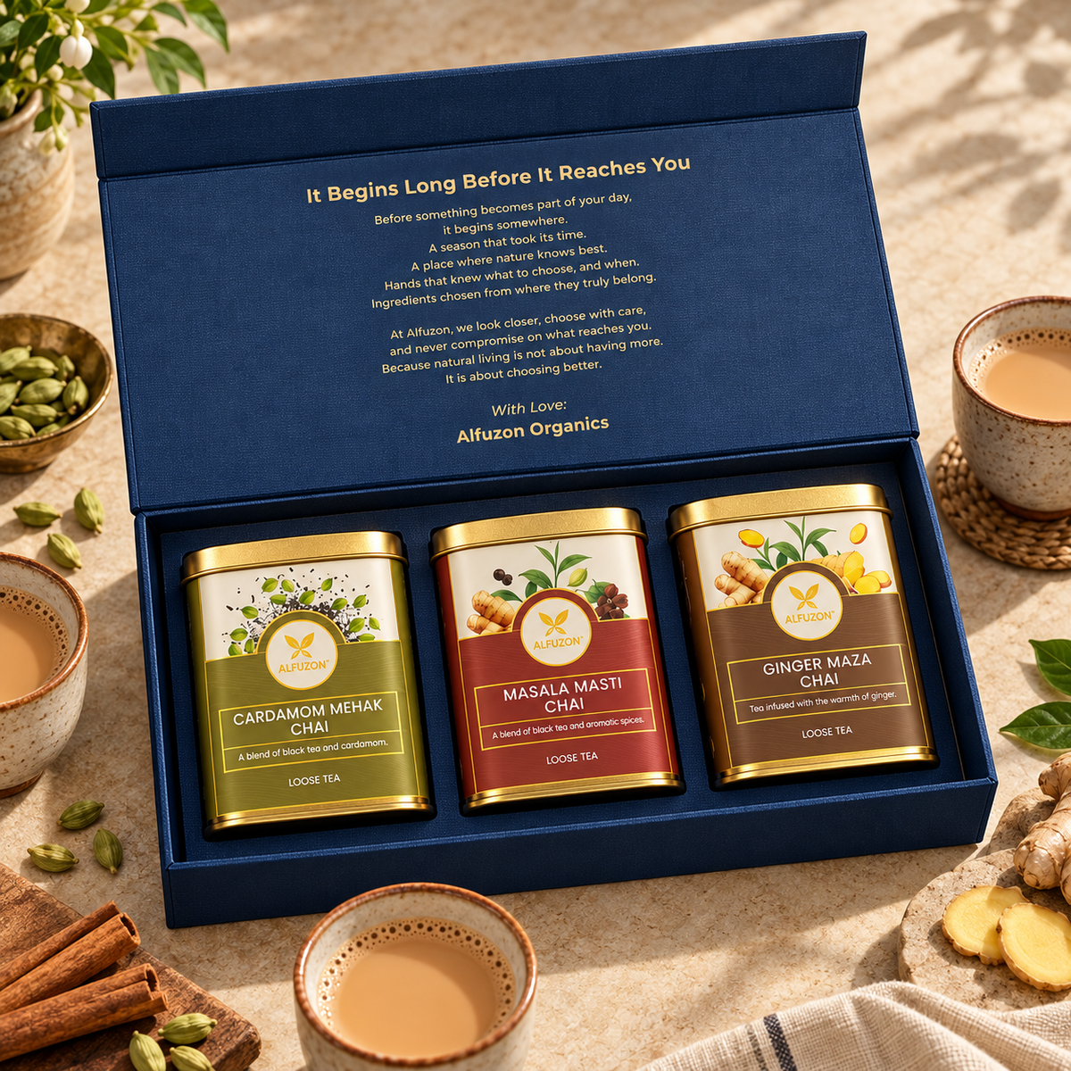 Alfuzon Chai Trio Gift Box beside three cups of milk chai